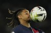 PSG's Bradley Barcola controls the ball during the French League One soccer match between Paris Saint-Germain and Lille at the Parc des Princes stadium in Paris, France, Saturday, Feb. 10, 2024. (AP Photo/Thibault Camus)