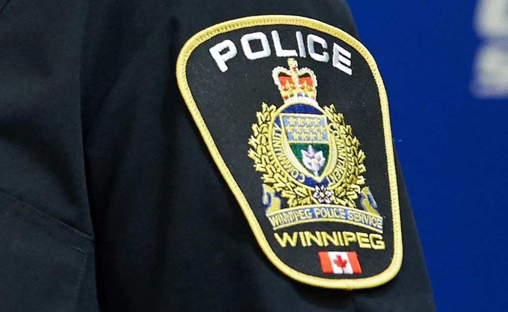 A Winnipeg Police Service shoulder badge is seen on Sept. 2, 2021 at the Public Information Office in Winnipeg. Police in Winnipeg say multiple officers were shot during a standoff at an apartment building where they were responding to a report of a person being held against her will. THE CANADIAN PRESS/David Lipnowski