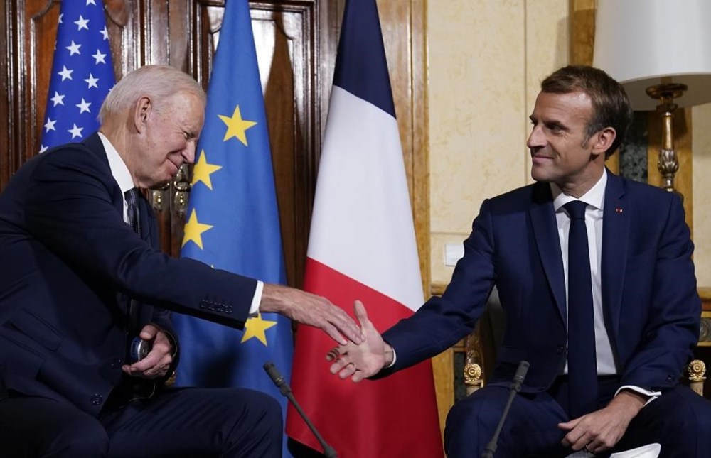 FILE - U.S. President Joe Biden, left, shakes hands with French President Emmanuel Macron during a meeting in Rome, Friday, Oct. 29, 2021. As chances rise of a Biden-Donald Trump rematch in the U.S. presidential election race, America’s allies are bracing for a bumpy ride. Macron’s recent verdict was blunt: America’s “first priority is itself.” (AP Photo/Evan Vucci, File)