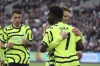 Arsenal's Bukayo Saka celebrates with teammate Arsenal's Martin Odegaard after scoring his sides 5th goal of the game during the English Premier League soccer match between West Ham United and Arsenal at the London Stadium in London, Sunday, Feb. 11, 2024. (AP Photo/Ian Walton)