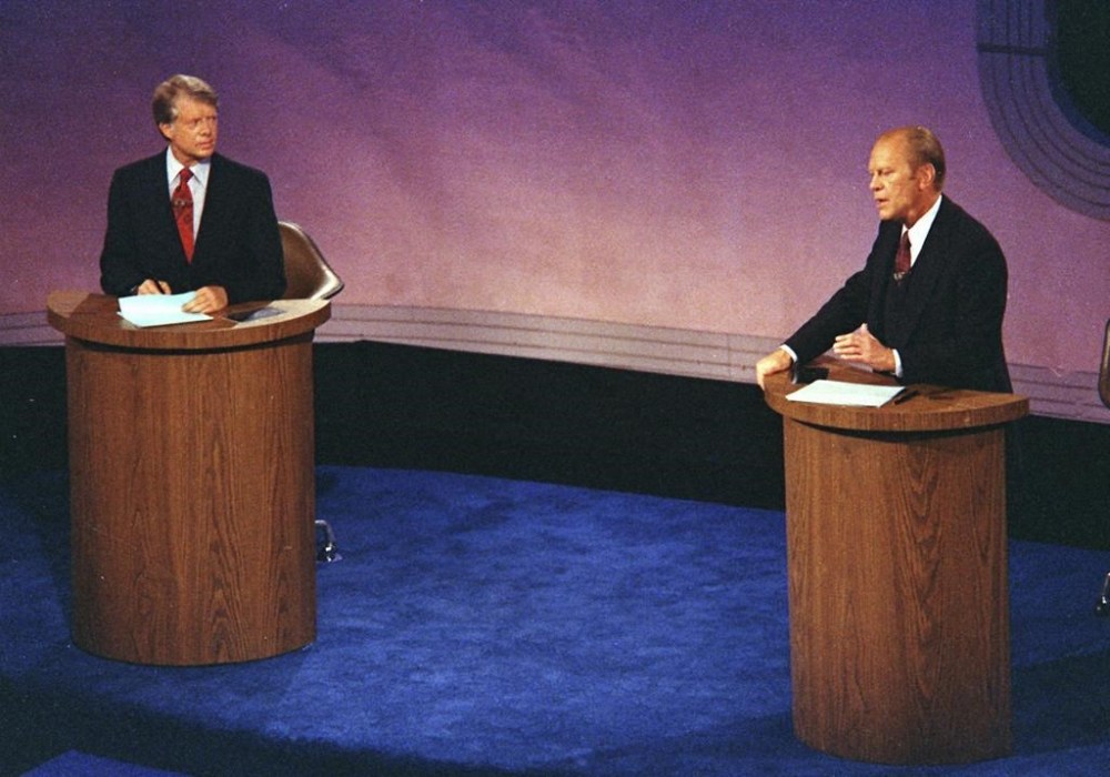 FILE - President Gerald Ford, right, speaks as Jimmy Carter listens during the first of three televised debates on Sept. 23, 1976, in Philadelphia. Presidential debates didn't become a recurring event until 1976 when the League of Women Voters began sponsoring them. There are real questions about whether any of the presidential candidates will confront each other on a debate stage in 2024. (AP Photo)