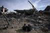 Palestinians inspect the damage to residential buildings where two Israeli hostages were reportedly held before being rescued during an operation by Israeli security forces in Rafah, southern Gaza Strip, Monday, Feb. 12, 2024. The Israeli military said early Monday that it had rescued the two hostages from captivity in the Gaza Strip. The operation, which was accompanied by airstrikes, killed dozens of Palestinians, according to local health officials. (AP Photo/Fatima Shbair)