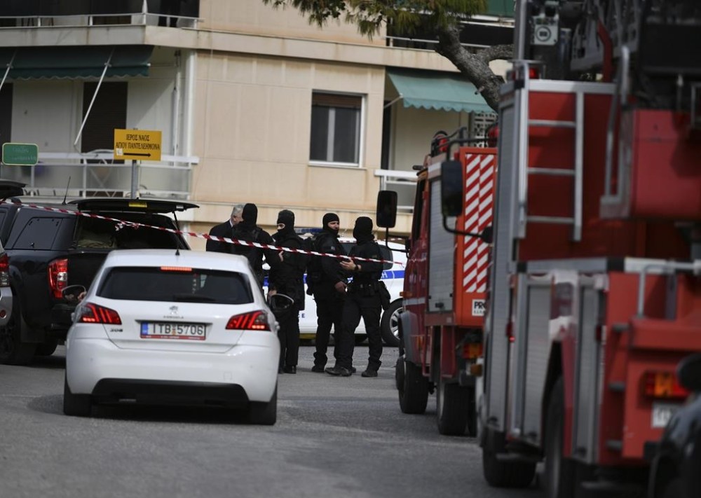 Police cordon off a road during an operation in the southern suburb of Glyfada, in Athens, Greece, Monday, Feb. 12, 2024. Three people have been shot dead at the offices of a shipping company near Athens while the suspected gunman also took his life as police special forces prepared to confront him. (AP Photo/Michael Varaklas)
