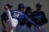Los Angeles Dodgers pitcher Yoshinobu Yamamoto (18) follows through as teammates stand in the shade during the first day of spring training baseball workouts at Camelback Ranch in Phoenix, Friday, Feb. 9, 2024. (AP Photo/Carolyn Kaster)