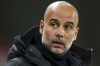 Manchester City's head coach Pep Guardiola looks out from the bench prior the English Premier League soccer match between Brentford and Manchester City at the Gtech Community Stadium in London, Monday, Feb. 5, 2024. (AP Photo/Ian Walton)