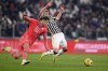 Juventus' Arkadiusz Milik, right, and Udinese's Lorenzo Lucca, left, challenge for the ball during a Serie A soccer match between Juventus and Udinese, in Turin, Italy, Monday, Feb. 12, 2024 (Fabio Ferrari/LaPresse via AP)