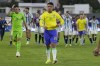 Brazil's Geovane (21) and goalkeeper Matheus Donelli (12) walk off the field after their 0-1 lost against Argentina in the last soccer match of the South America's under-23 pre-Olympic tournament at Brigido Iriarte stadium in Caracas, Venezuela, Sunday, Feb. 11, 2024. (AP Photo/Ariana Cubillos)