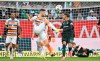Mainz's Tom Krauss, center, takes on Bremen's Justin Njinmah during the German Bundesliga soccer match between Mainz and Werder Bremen, at the Mewa Arena in Mainz, Germany, Saturday, Feb. 3, 2024. (Torsten Silz/dpa via AP)