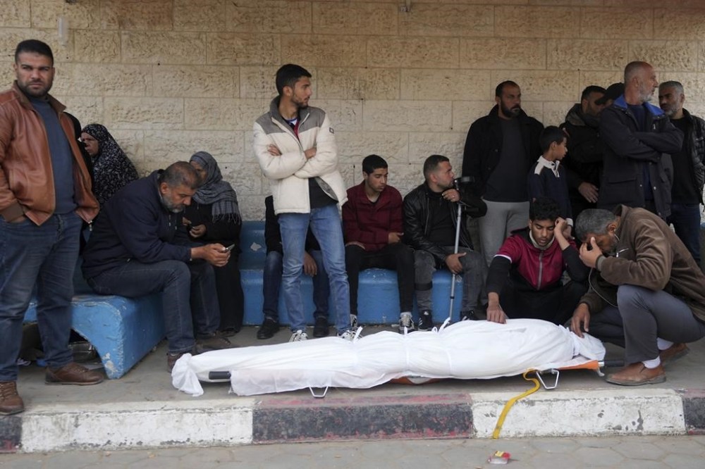 Palestinians mourn a relative killed in the Israeli bombing of the Gaza Strip in Deir al Balah on Tuesday, Feb. 13, 2024. (AP Photo/Adel Hana)