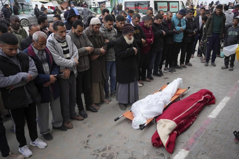 Palestinians mourn their relatives killed in the Israeli bombing of the Gaza Strip in Deir al Balah on Tuesday, Feb. 13, 2024. (AP Photo/Adel Hana)