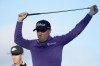 Justin Thomas stretches as he waits to tee off at the third hole during the first round of the Phoenix Open golf tournament Thursday, Feb. 8, 2024, in Scottsdale, Ariz. (AP Photo/Ross D. Franklin)
