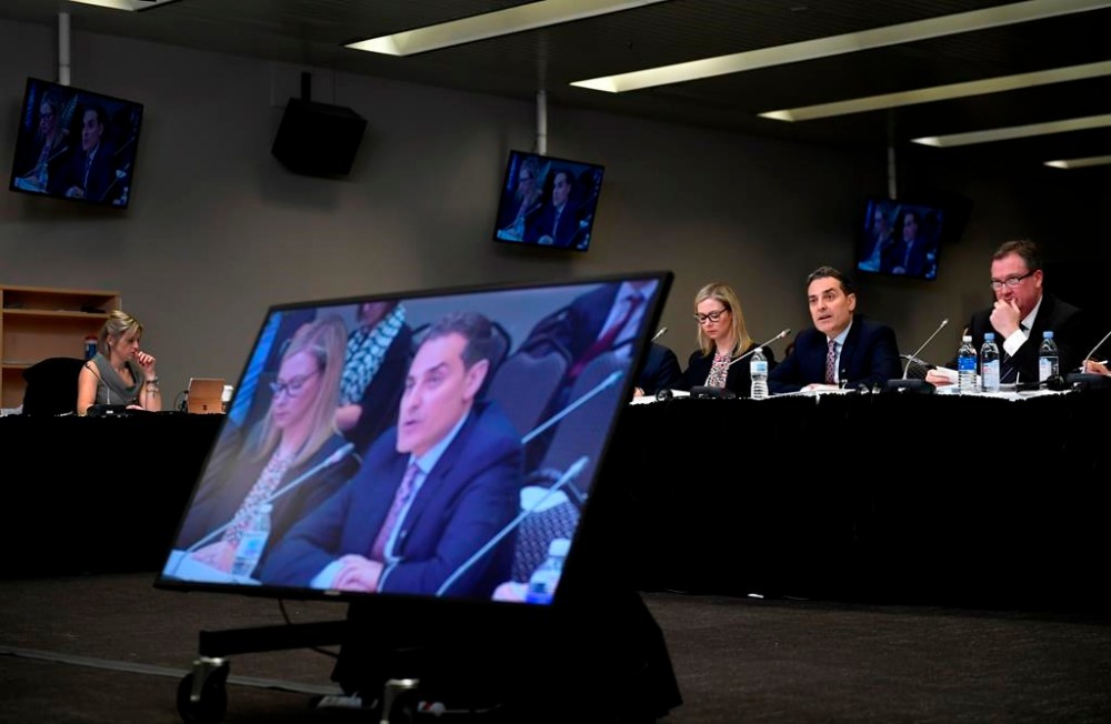 Mirko Bibic, president and CEO of BCE and Bell Canada is seen on television screens as he speaks during a CRTC hearing in Gatineau, Que., on Wednesday, Feb. 19, 2020. Members of Parliament have invited several top executives from BCE Inc. and Bell Canada to testify later this month about the company's decision to cut about nine per cent of its workforce this year. THE CANADIAN PRESS/Justin Tang