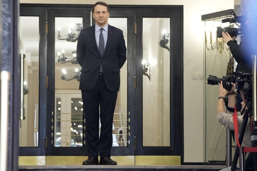 Poland's Foreign Minister Radek Sikorski waits for the arrival of his Estonian counterpart Margus Tsahkna for talks on regional security and continuing support for Ukraine in its struggle against Russia's invasion, at the Foreign Ministry in Warsaw, Poland, Wednesday Feb. 14, 2024. Estonia's foreign minister said Wednesday that NATO has about three or four years to beef up its defenses against Russia because President Vladimir Putin is ramp up his country's “war machine
