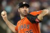 FILE - Houston Astros starting pitcher Justin Verlander throws against the Texas Rangers during the first inning in Game 5 of the baseball American League Championship Series Friday, Oct. 20, 2023, in Arlington, Texas. Houston Astros ace Justin Verlander says he is “a little bit behind schedule” due to offseason shoulder inflammation that could prevent him from being ready to pitch on opening day. The three-time Cy Young Award winner spoke Wednesday, Feb. 14, 2024, on the first official day for pitchers and catchers at Astros camp.(AP Photo/Julio Cortez, File)