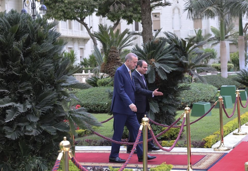 In this handout photo released by Turkish Presidency, Turkey's President Recep Tayyip Erdogan, left, is led by Egyptian President Abdel Fattah Al-Sissi for a welcome ceremony during their meeting at Al-Ittihadiya palace in Cairo, Egypt, Wednesday, Feb. 14, 2024. (Turkish Presidency via AP)