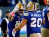 Winnipeg Blue Bombers' Dalton Schoen (83) and Brady Oliveira (20) celebrate Schoen’s touchdown against the B.C. Lions during first half CFL action in Winnipeg Friday, October 28, 2022.  THE CANADIAN PRESS/John Woods