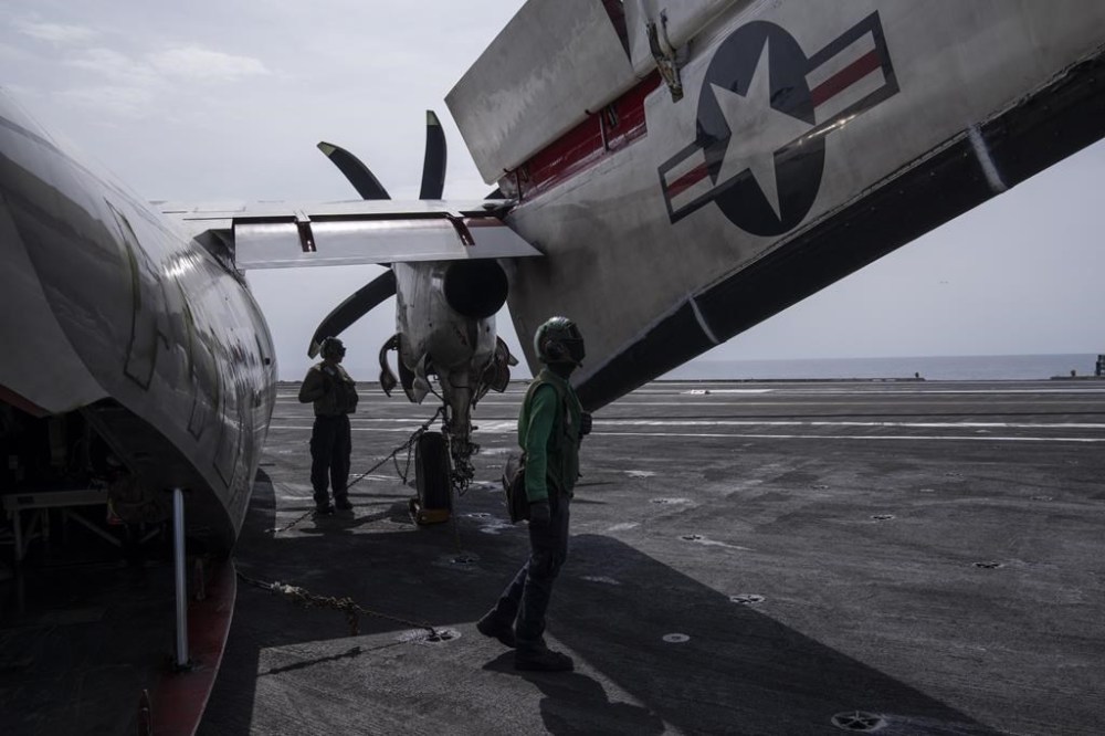 Crew members inspect C-2 Greyhound (COD) after landing at the U.S.S. aircraft carrier Dwight D. Eisenhower, also known as the 'Ike', on the south Red Sea, Monday, Feb. 12, 2024. (AP Photo/Bernat Armangue)