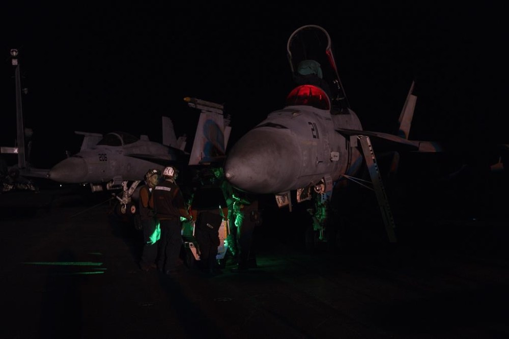 Aviation ordnance men work on the deck of the U.S.S. aircraft carrier Dwight D. Eisenhower, also known as the 'Ike', on the south Red Sea, Monday, Feb. 12, 2024. (AP Photo/Bernat Armangue)
