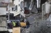 Civil defence and rescue workers remove rubbles from a building that was attacked Wednesday night by an Israeli airstrike, in Nabatiyeh town, south Lebanon, Thursday, Feb. 15, 2024. The airstrike killed and injured several people and child, Lebanon's state news agency reported. (AP Photo/Mohammed Zaatari)