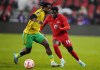 Canada's Alphonso Davies (19) moves past Jamaica's Dexter Lembikisa (2) during first half CONCACAF Nations League quarterfinal soccer action in Toronto on Tuesday, November 21, 2023. Canada fell two places to No. 50, sandwiched between Greece and Cameroon, in the latest FIFA world rankings. THE CANADIAN PRESS/Chris Young