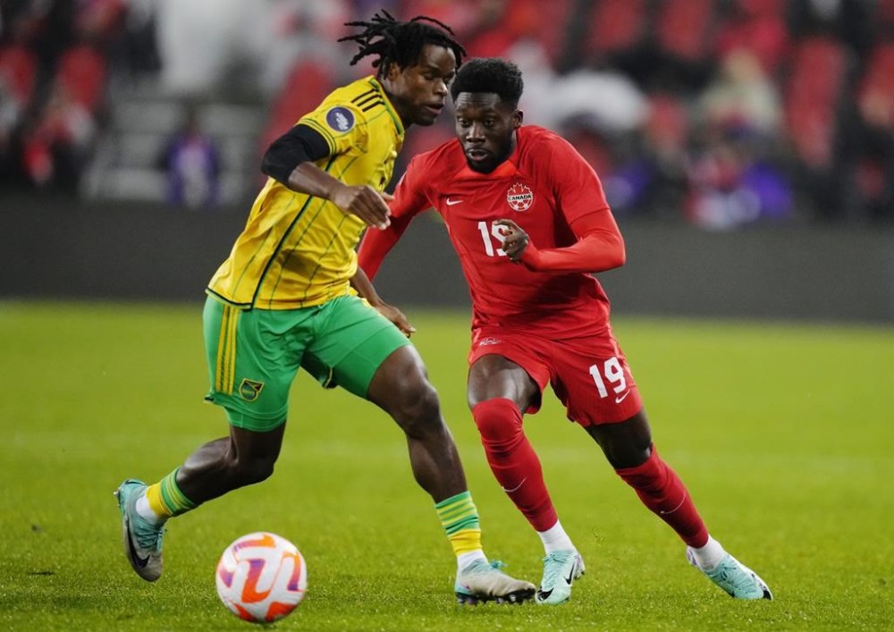 Canada's Alphonso Davies (19) moves past Jamaica's Dexter Lembikisa (2) during first half CONCACAF Nations League quarterfinal soccer action in Toronto on Tuesday, November 21, 2023. Canada fell two places to No. 50, sandwiched between Greece and Cameroon, in the latest FIFA world rankings. THE CANADIAN PRESS/Chris Young