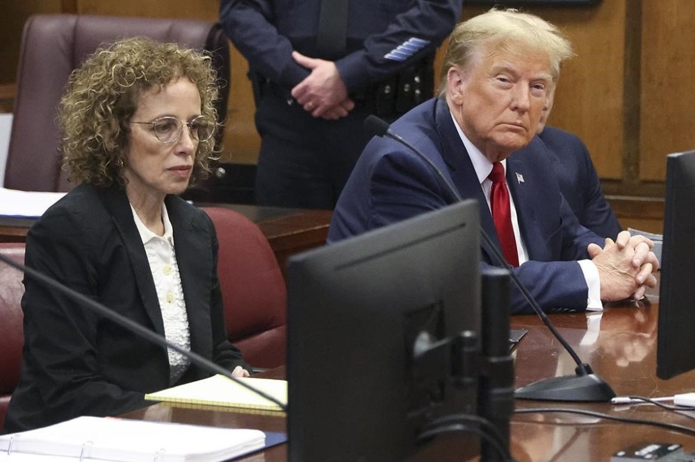 Donald Trump awaits the start of a hearing in New York City Criminal Court, Thursday, February 15, 2024. A New York judge says former President Donald Trump's hush-money trial will go ahead as scheduled with jury selection starting on March 25. (Jefferson Siegel for The New York Times via AP, Pool)