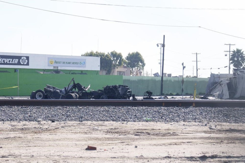 The tractor portion of a big rig is shown on Thursday, Feb. 15, 2024 in the Wilmington section of Los Angeles. Several Los Angeles firefighters were injured, two critically, when an explosion occurred as they responded to a truck with pressurized cylinders that were on fire early Thursday, authorities said. (AP Photo/Eric Thayer)