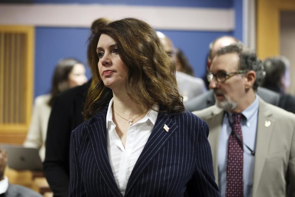 Fulton County Special prosecutor Anna Cross, who is representing the Fulton County District Attorney's office, enters the courtroom for a hearing in the Georgia election interference case, Thursday, Feb. 15, 2024, in Atlanta. The hearing is to determine whether Fulton County District Attorney Fani Willis should be removed from the case because of a relationship with Nathan Wade, special prosecutor she hired in the election interference case against former President Donald Trump. (Alyssa Pointer/Pool Photo via AP)