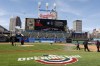 FILE - The Cleveland Guardians grounds crew prepares the field for the home opener baseball game against the Seattle Mariners, Friday, April 7, 2023, in Cleveland. The Guardians will throw the first pitch at their 2024 home opener after the earth, moon and sun align. Cleveland's first game at Progressive Field against the Chicago White Sox will begin on April 8 at 5:10 p.m. — two hours following a total solar eclipse, an event that hasn't happened in Northeast Ohio since 1806 and won't again until 2444.(AP Photo/Ron Schwane, File)