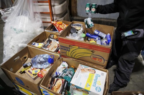 For grocers, selling perishable items means making continual choices about every item on display — especially the ones nearing the end of their shelf life. Food and goods are sorted to be sent to a food bank at a Metro grocery store In Toronto on Friday, Feb. 2, 2024. For those that don’t sell in time, many stores donate them to food banks rather than throw them away. THE CANADIAN PRESS/Cole Burston