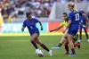 FILE - U.SS. midfielder Lindsey Horan (10) passes the ball to forward Alyssa Thompson (9) past Colombia midfielder Lorena Bedoya during the second half of an international friendly soccer match Oct. 29, 2023, in San Diego. Horan apologized for comments she made about American viewers in a recent interview, saying the remarks were “poorly expressed.” (AP Photo/Alex Gallardo, File)