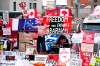 Representatives of the so-called Freedom Convoy are planning to hold a press conference in Ottawa this afternoon, two years after the police action that ended the occupation of downtown Ottawa streets. A protester dances on a concrete jersey barrier in front of vehicles and placards on Rideau Street in Ottawa, on Wednesday, Feb. 16, 2022. THE CANADIAN PRESS/Justin Tang