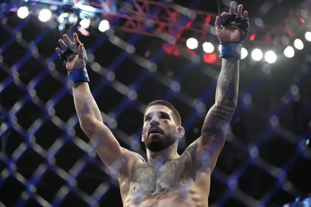 FILE - Ilia Topuria celebrates after defeating Bryce Mitchell in a UFC 282 mixed martial arts featherweight bout Saturday, Dec. 10, 2022, in Las Vegas. Topuria thinks Saturday, Feb. 17, 2024, is his chance to end Alexander Volkanovski's four-year reign at 145 pounds. (AP Photo/John Locher, File)