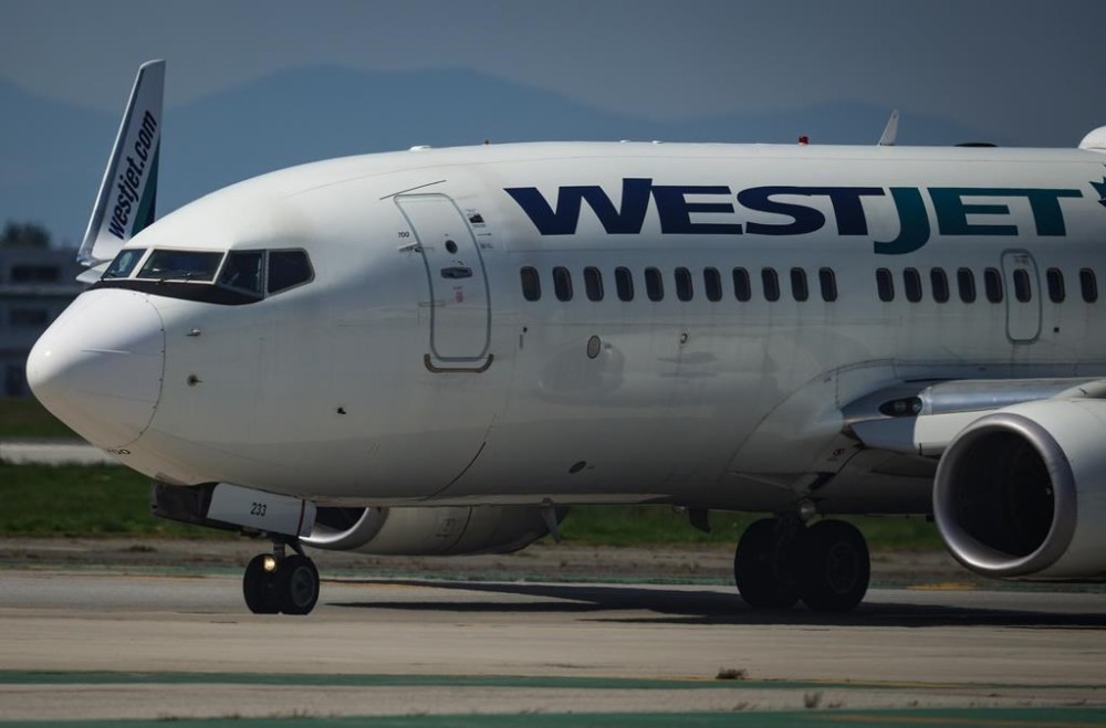 Pilots taxi a WestJet Boeing 737-700 aircraft to the runway for departure from Vancouver International Airport, in Richmond, B.C., on Friday, May 19, 2023. A flight from Vancouver to Toronto made an unscheduled stop after a passenger attempted to open a door. WestJet says in an email that Flight 710 diverted to Winnipeg after the incident on Friday.;THE CANADIAN PRESS/Darryl Dyck