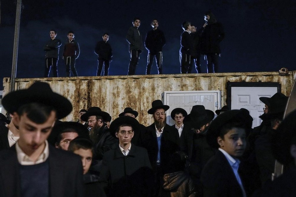 Mourners attend the funeral of Yishai Gartner in the West Bank settlement of Modiin Ilit on Saturday, Feb. 17, 2024. Gartner, 23, and a reservist were killed in a shooting attack on Friday by a Palestinian gunman at Re'em junction in southern Israel. Police say the man opened fire at a bus stop, killing two and wounding several people before he was shot and killed by a civilian. (AP Photo/Ohad Zwigenberg)