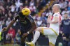 Real Madrid's Aurelien Tchouameni, left, challenges for the ball with Rayo's Isi Palazon during the Spanish La Liga soccer match between Rayo Vallecano and Real Madrid at the Vallecas stadium in Madrid, Spain, Sunday, Feb. 18, 2024. (AP Photo/Manu Fernandez)