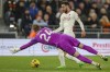 Luton Town's goalkeeper Thomas Kaminski, front, tries to block a shot from Manchester United's Bruno Fernandes during the English Premier League soccer match between Luton Town and Manchester United at Kenilworth Road, in Luton, England, Sunday, Feb. 18, 2024. (AP Photo/Ian Walton)