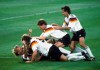 FILE - Germany players celebrate after Andreas Brehme, left on ground, scores the winning goal in the World Cup soccer final match against Argentina, in the Olympic Stadium, in Rome, July 8, 1990. Andreas Brehme, who scored the only goal as West Germany beat Argentina to win the 1990 World Cup final, has died. He was 63. Brehme’s partner Susanne Schaefer has confirmed his death in a statement to Germany’s dpa news agency. (AP Photo/Carlo Fumagalli, File)
