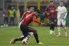 Rennes' Guela Doue challenges for the ball with AC Milan's Rafael Leao during the Europa League play-off first leg soccer match between AC Milan and Rennes at the San Siro Stadium, in Milan, Italy, Thursday, Feb. 15, 2024. (AP Photo/Antonio Calanni)