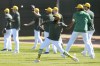 Oakland Athletics players warm up during a baseball spring training workout, Friday, Feb. 16, 2024, in Mesa, Ariz. (AP Photo/Matt York)