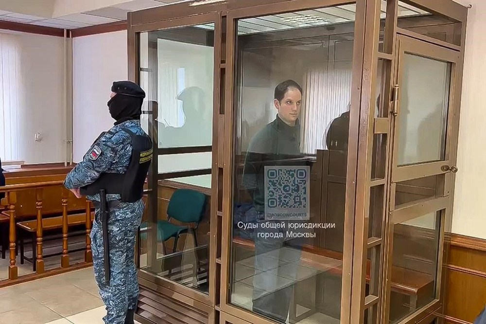 In this photo taken from video released by the Moscow's City Court, Wall Street Journal reporter Evan Gershkovich stands in a glass cage in a courtroom at the Moscow City Court, in Moscow, Russia, on Tuesday, Feb. 20, 2024. (Moscow City Court via AP)