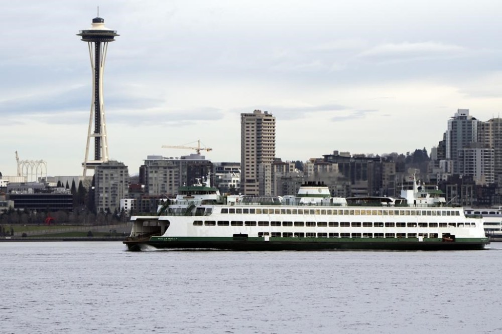 A Washington State ferry travels into Elliott Bay in Seattle on Saturday, Feb. 17, 2024. The U.S. Coast Guard is embarking on one of its most unique missions yet in the Puget Sound: a pilot program to alert vessels of whale sightings. The program is an effort to keep the giant marine mammals safe from boat strikes and noise in the highly used inland waters of Washington state. (AP Photo/Jenny Kane)