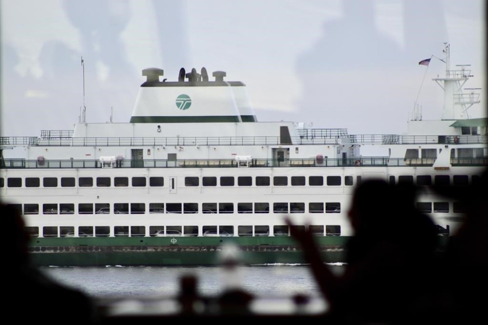 A ferry is seen sailing from inside the galley of another ferry by Bainbridge Island, Wash., on Saturday, Feb. 10, 2024. The U.S. Coast Guard is launching a whale alert program in Washington state’s Salish Sea to help commercial and transit ships steer clear of the marine mammals. Using sighting reports from mariners and civilians and hydrophone monitoring, the so-called