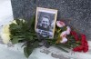 This grab taken from video shows flowers and a portrait of Russian opposition leader Alexei Navalny that Lyudmila Navalnaya, mother of Russian opposition leader Alexei Navalny, put to pay tribute to her son at the at the memorial to victims of political repression, in Salekhard, 1937 km (1211 miles) northeast of Moscow, Russia, on Tuesday, Feb. 20, 2024. Russians across the vast country streamed to ad-hoc memorials with flowers and candles to pay tribute to Alexei Navalny, the most famous Russian opposition leader and the Kremlin's fiercest critic. Russian officials reported that Navalny, 47, died in prison on Friday. (AP Photo)
