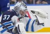 Winnipeg Jets goaltender Connor Hellebuyck makes a glove save during the third period of an NHL hockey game against the Vancouver Canucks in Vancouver, on Saturday, Feb. 17, 2024. THE CANADIAN PRESS/Darryl Dyck