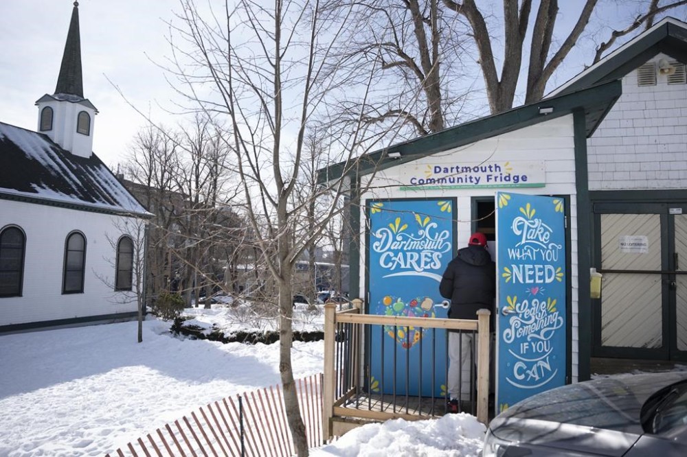 A person uses the community fridge to fill a bag with donated food in Dartmouth, N.S., on Wednesday, Feb. 21, 2024. THE CANADIAN PRESS/Darren Calabrese