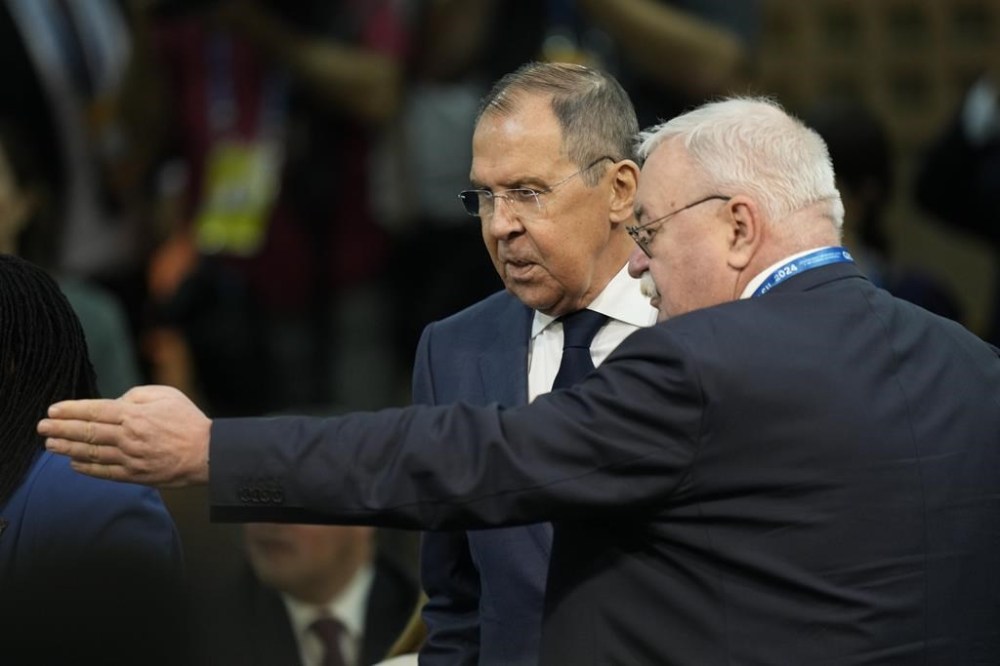 Russia's Foreign Minister Sergei Lavrov, left, arrives to the G20 foreign ministers meeting in Rio de Janeiro, Brazil, Wednesday, Feb. 21, 2024. (AP Photo/Silvia Izquierdo)