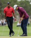 FILE -Tiger Woods, left, watches his son Charlie, right, putt ball during the final round of the PNC Championship golf tournament Sunday, Dec. 17, 2023, in Orlando, Fla. Charlie Woods, 15, will be playing a pre-qualifier on Thursday in Hobe Sound, Fla., the first step before a full qualifier for the Cognizant Classic on the PGA Tour. (AP Photo/Kevin Kolczynski, File)