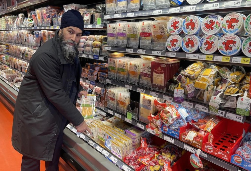 NDP Leader Jagmeet Singh points to a $20 package of cheese during a visit to a Loblaws grocery store in Ottawa on Wednesday Feb. 21, 2024. Singh has made it a central tenet of his party's policy to take on big companies he believes are making record profits while ordinary people struggle to afford the basics. 
THE CANADIAN PRESS/Mickey Djuric
