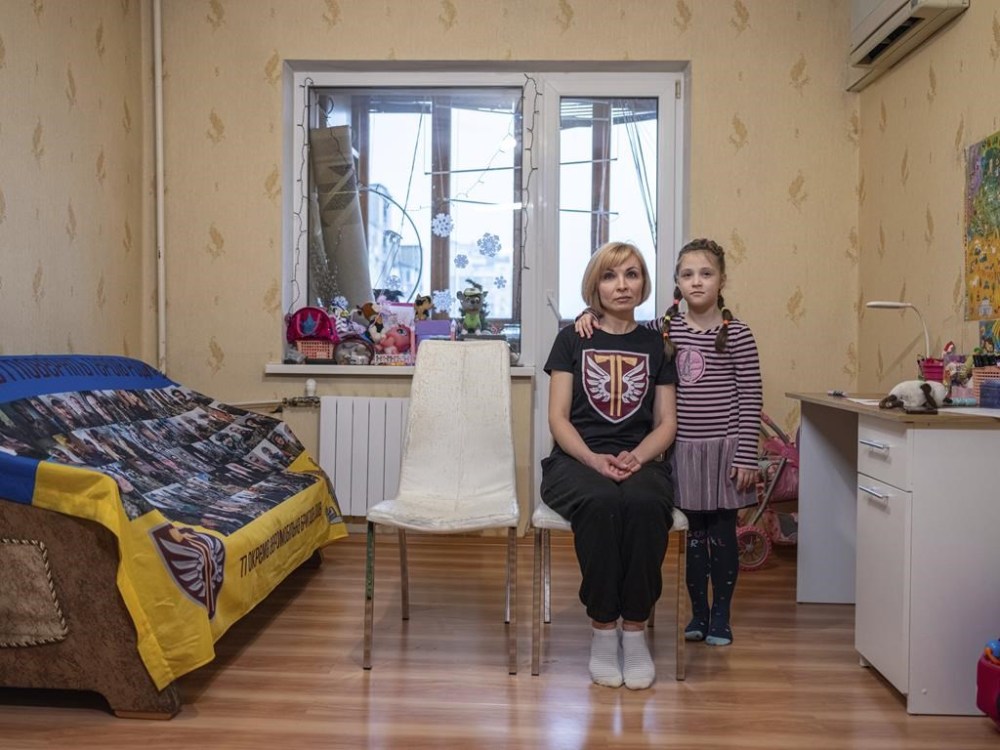 Nina Tkachenko, 47, sits with her daughter Polina, 7, awaiting the return of her husband Vasyl at their rented apartment in Kyiv, Ukraine on Feb. 15, 2024. Vasyl Yurchuk, 39, a Ukrainian serviceman with the 77th Air Assault Brigade went missing during an evacuation operation of an injured comrade at the frontline in Paraskoviivka, Donetsk region, on Jan. 27, 2023. Before the full-scale invasion he was a former private businessman selling windows. (AP Photo/Evgeniy Maloletka)
